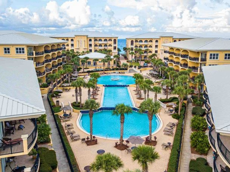 aerial view of resort-style condo community with pool