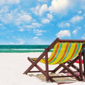 two chairs on the beach overlooking emerald waters