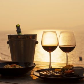 View of wine glasses in front of a sunset showing the best of Sandestin dining