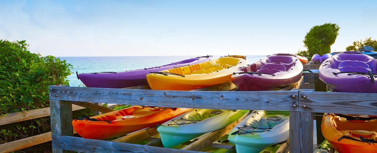 Santa Rosa Beach Kayak rentals stacked up overlooking the ocean and the beach