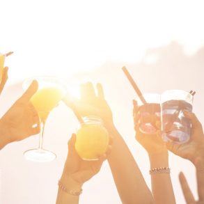 hands up to the sky with cocktails. people at Sandestin Events