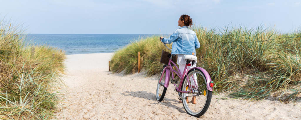 woman on bike on beach