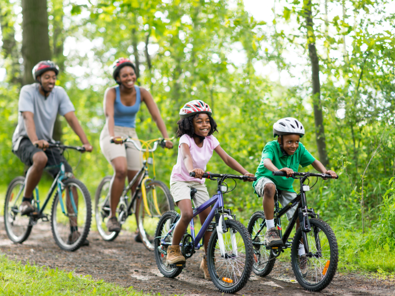 african american family on a bike ride on a trail