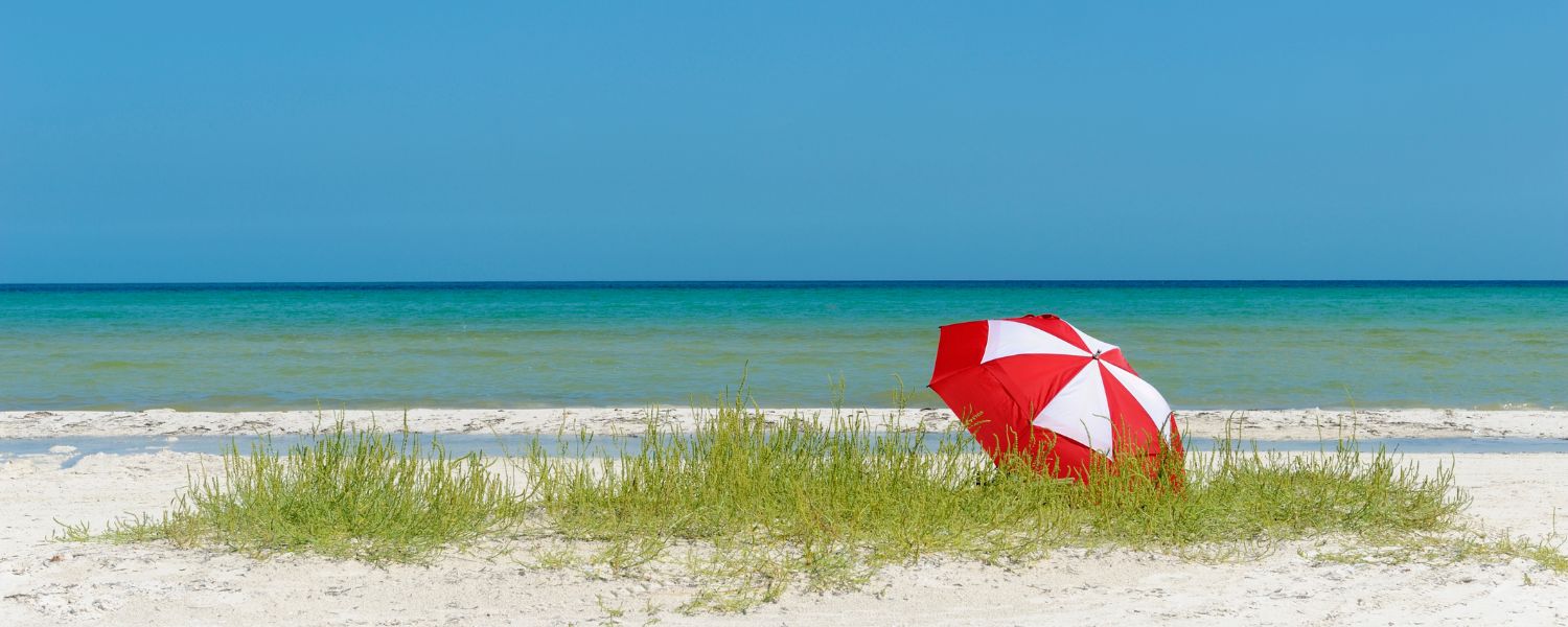 red and white beach umbrella on beach