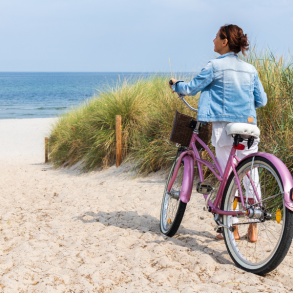 30a biking, woman with bike on beach