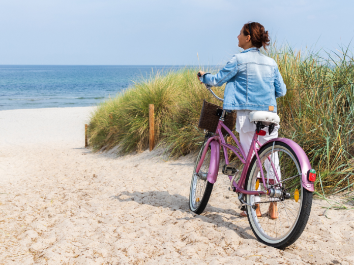 30a biking, woman with bike on beach