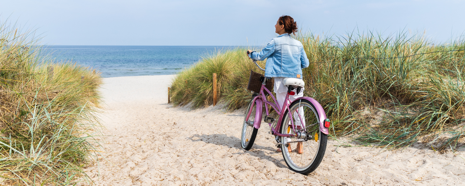 30a biking, woman with bike on beach
