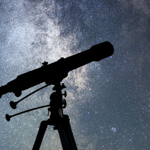 woman with telescope against night sky