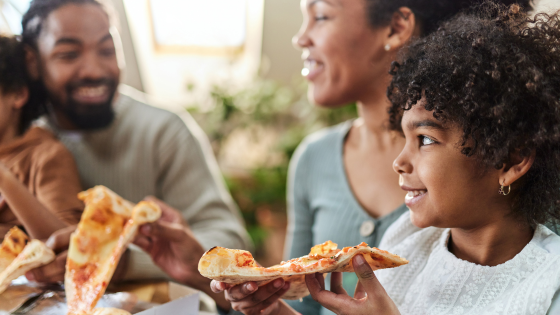 family eating pizza together