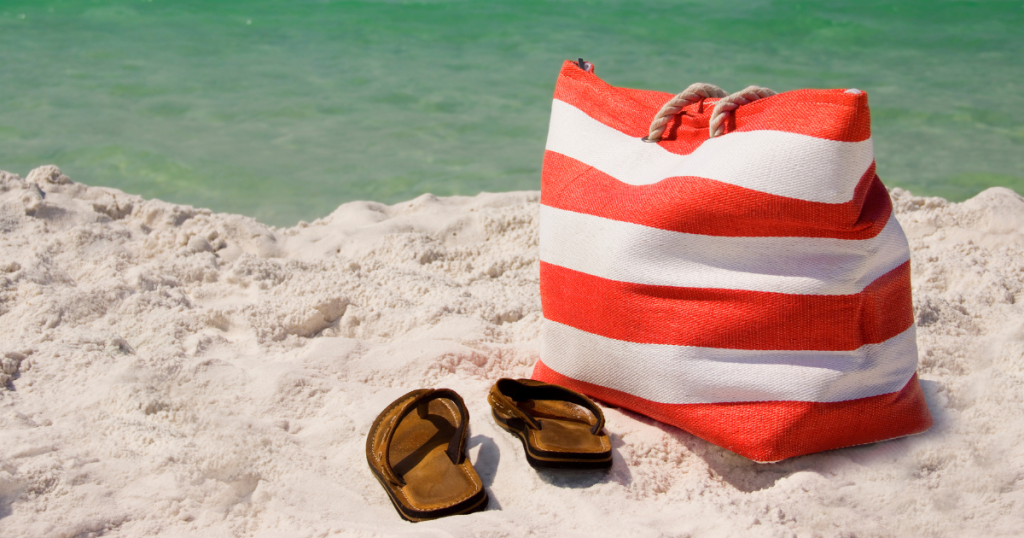 beach bag on beach with flip flop