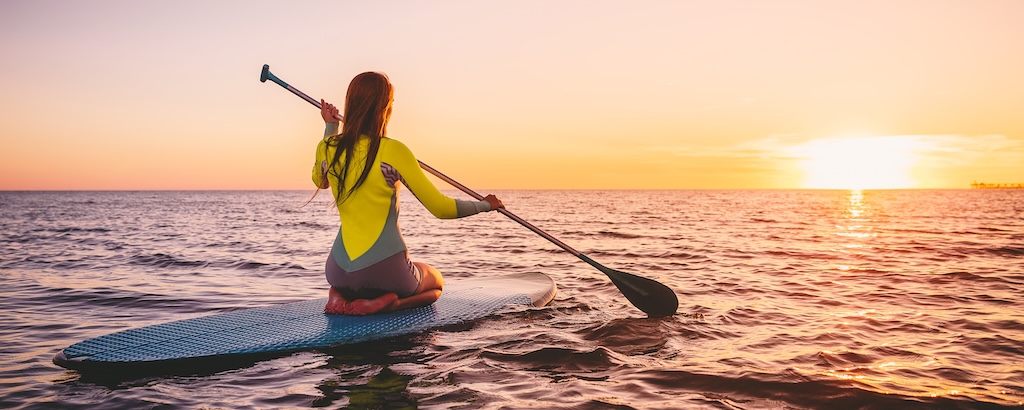 A woman paddleboarding 